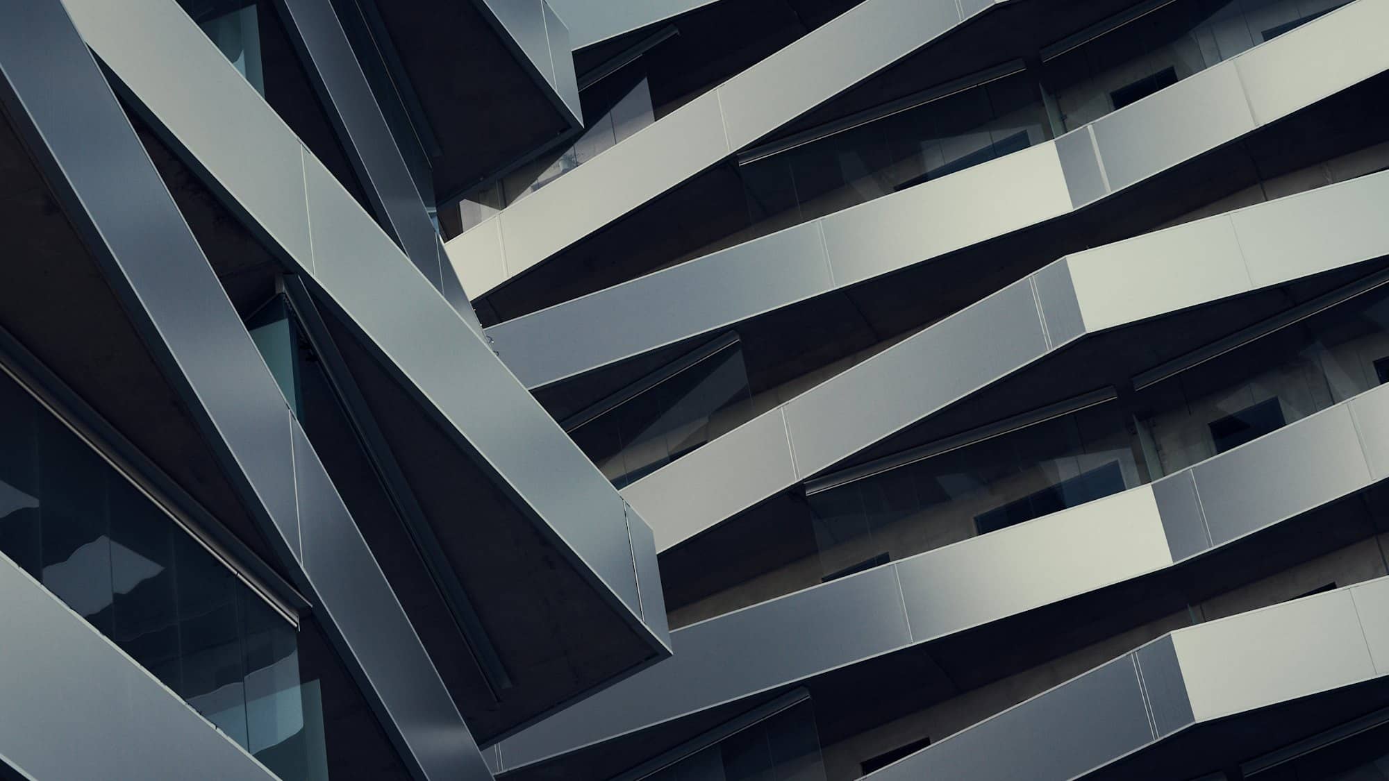 A dark angular building facade seen from below
