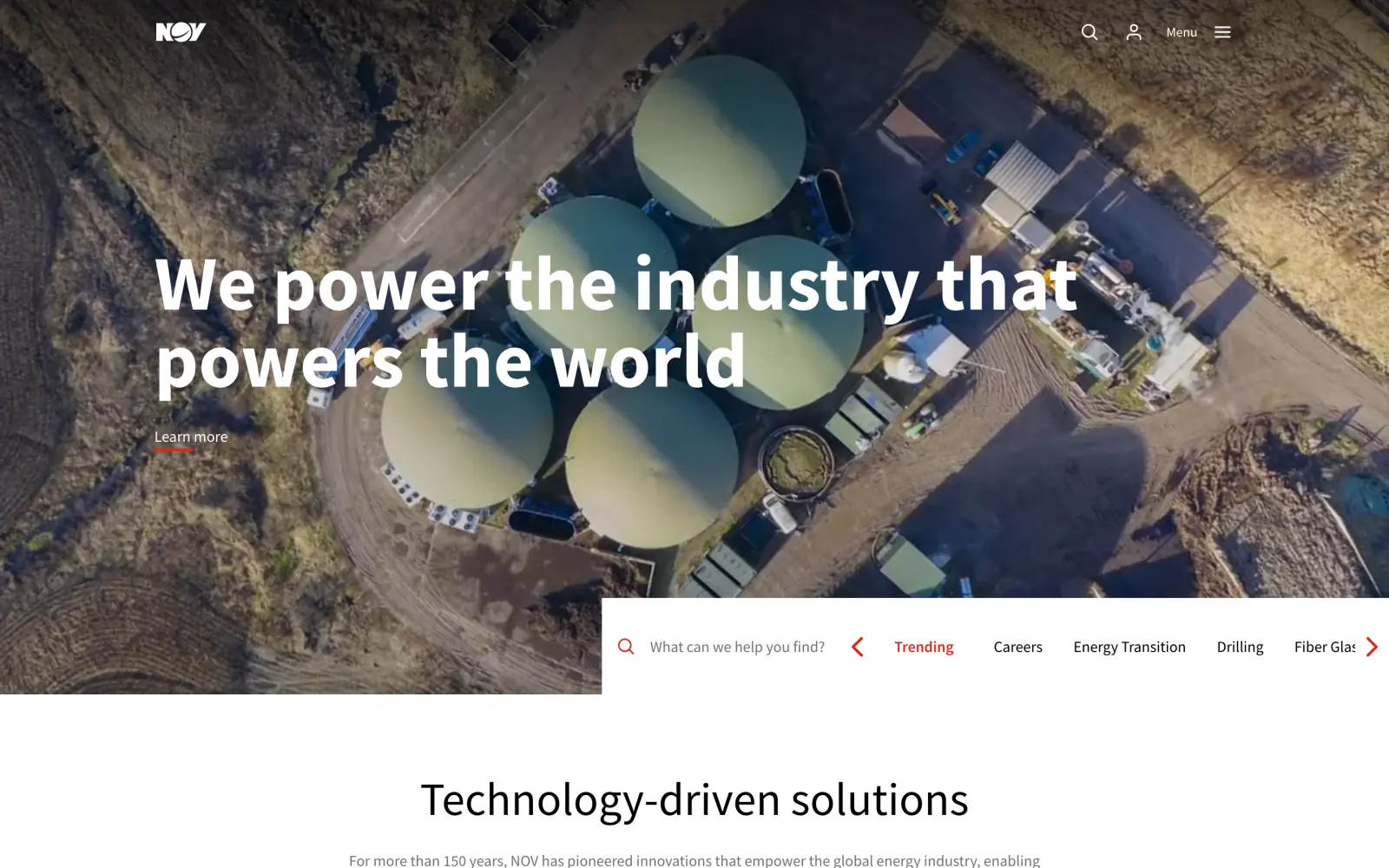 The NOV homepage: aerial footage of a site with round tanks behind the headline We power the industry that powers the world, and a search panel with trending topics at the foot of the hero.