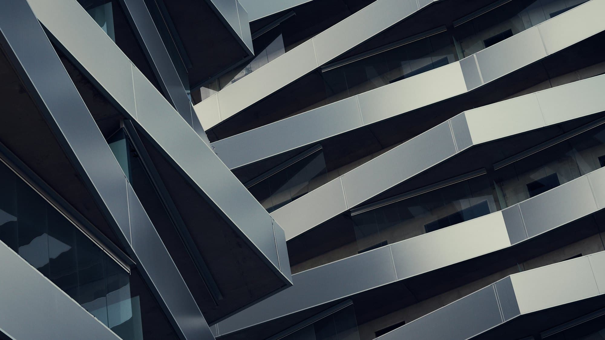 A dark angular building facade seen from below