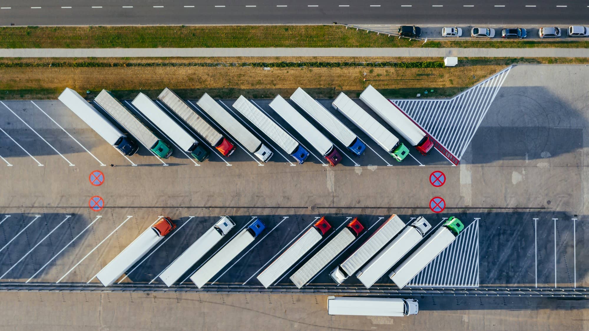 Articulated trailers parked in rows, seen from the air